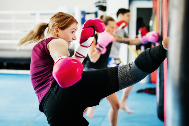 A group of women kickboxing and training together at their local gym.